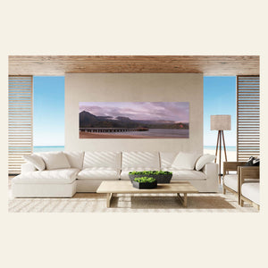 A Hanalei Bay sunrise picture from Kauai hangs in a living room.