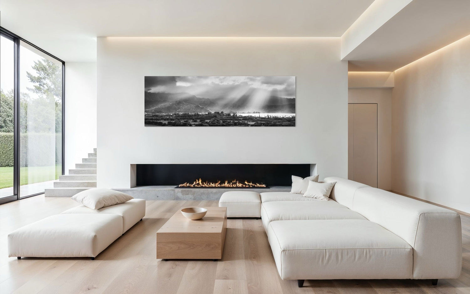 A piece of Hanalei black and white Kauai art hangs above a fireplace.