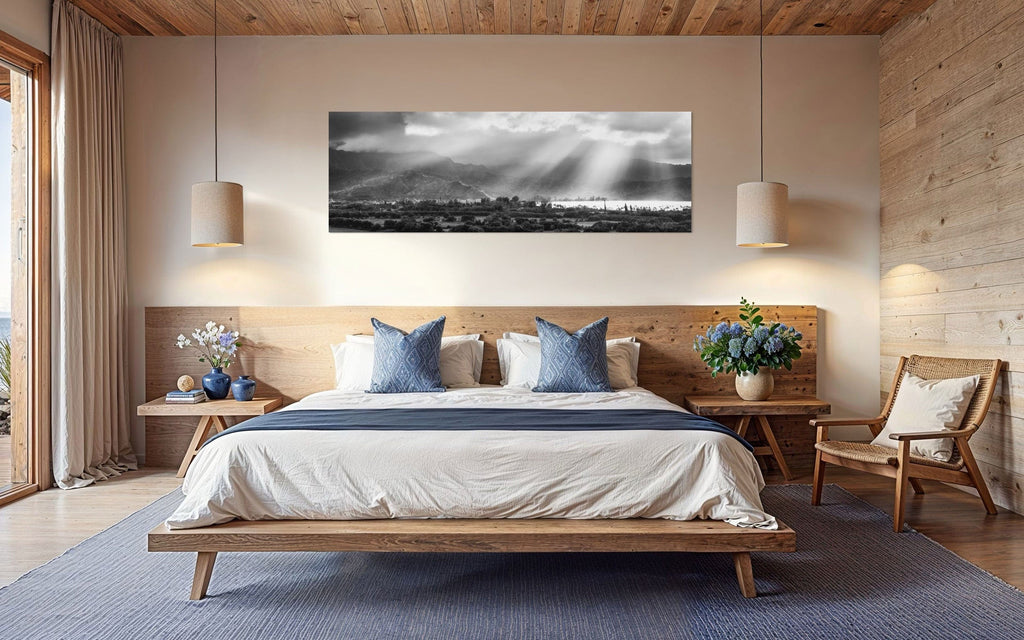 A piece of Hanalei black and white Kauai art hangs in a bedroom.