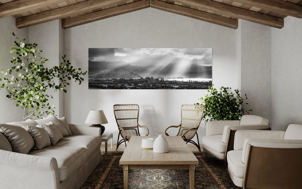 A piece of Hanalei black and white Kauai art hangs in a family room.