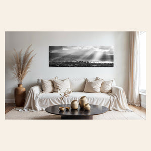 A piece of Hanalei black and white Kauai art hangs above a couch.