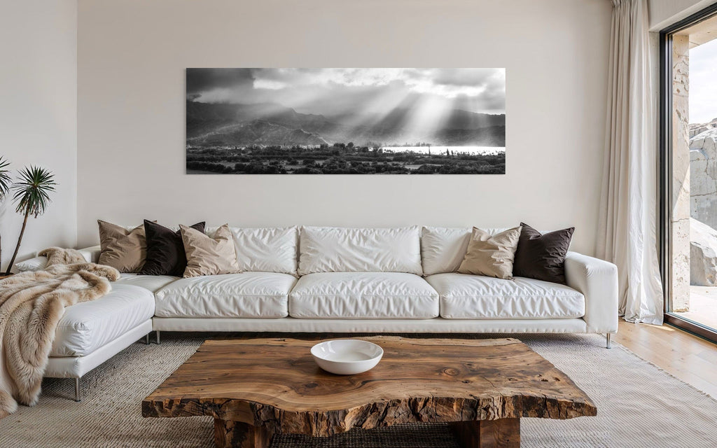 A piece of Hanalei black and white Kauai art hangs in a contemporary rustic living room.