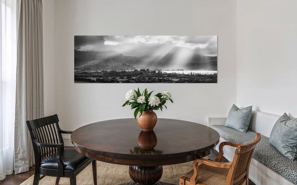 A piece of Hanalei black and white Kauai art hangs in a dining area.