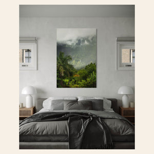 A piece of Kauai art showing the mountains seen from Hanalei hangs in a bedroom.