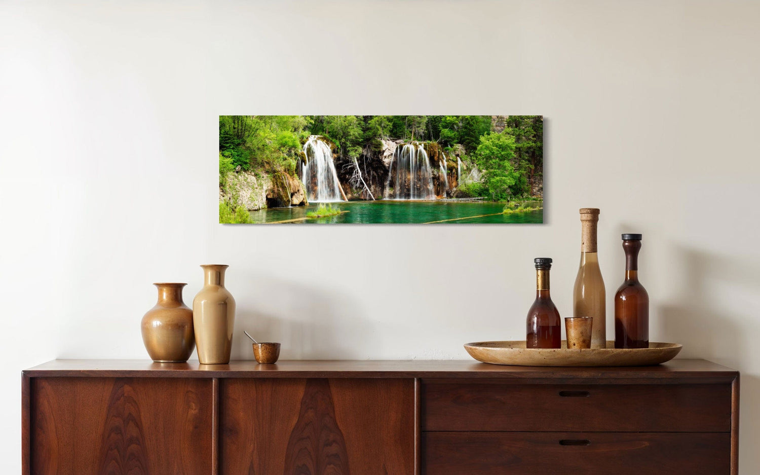 A piece of Colorado art showing a photo of the Hanging Lake waterfall hangs in a dining room.