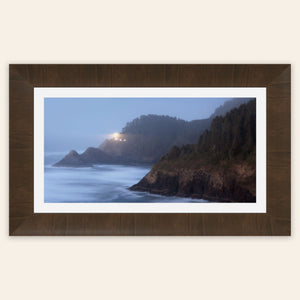 A piece of framed Oregon wall art shows Heceta Head Lighthouse.