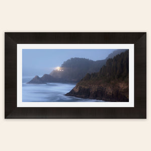 A piece of framed Oregon wall art shows Heceta Head Lighthouse.