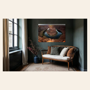 A piece of Arizona art showing a Horseshoe Bend sunset picture hangs in a sitting area.