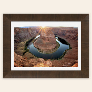 A piece of framed Arizona art shows a Horseshoe Bend sunset picture.