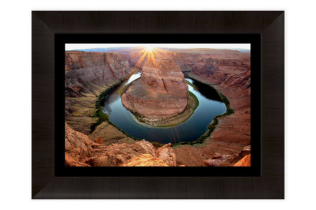 A framed Horseshoe Bend sunset picture.