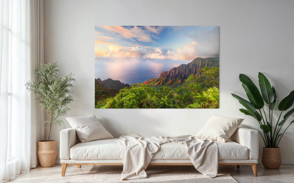 A piece of Kauai art showing a photo of sunset at the Napali Coast as seen from the Kalalau Valley Overlook hangs above a chaise lounge.