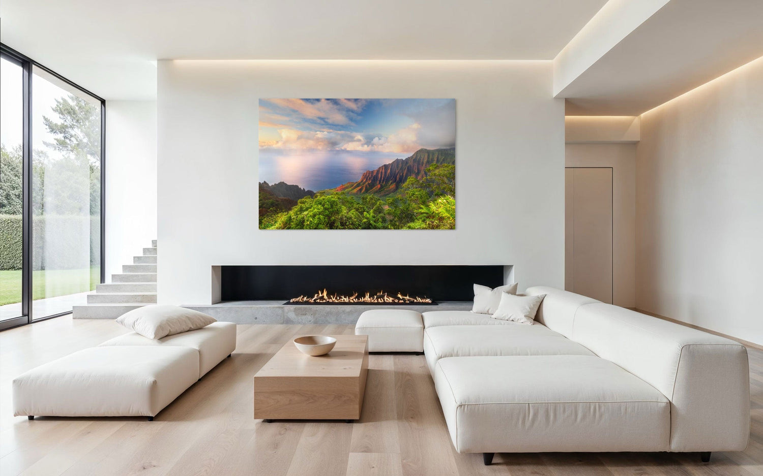 A piece of Kauai art showing a photo of sunset at the Napali Coast as seen from the Kalalau Valley Overlook hangs above a fireplace.