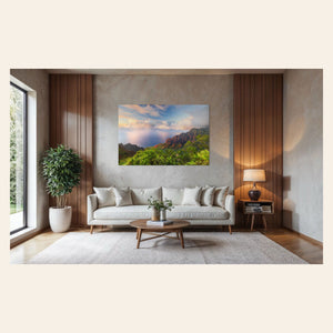 A piece of Kauai art showing a photo of sunset at the Napali Coast as seen from the Kalalau Valley Overlook hangs above a couch.