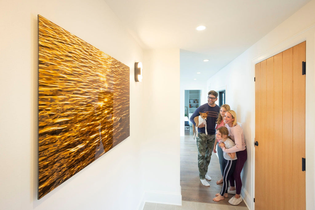 Happy collectors with Lars Gesing's piece of Kauai art showing a Kapaa sunrise.