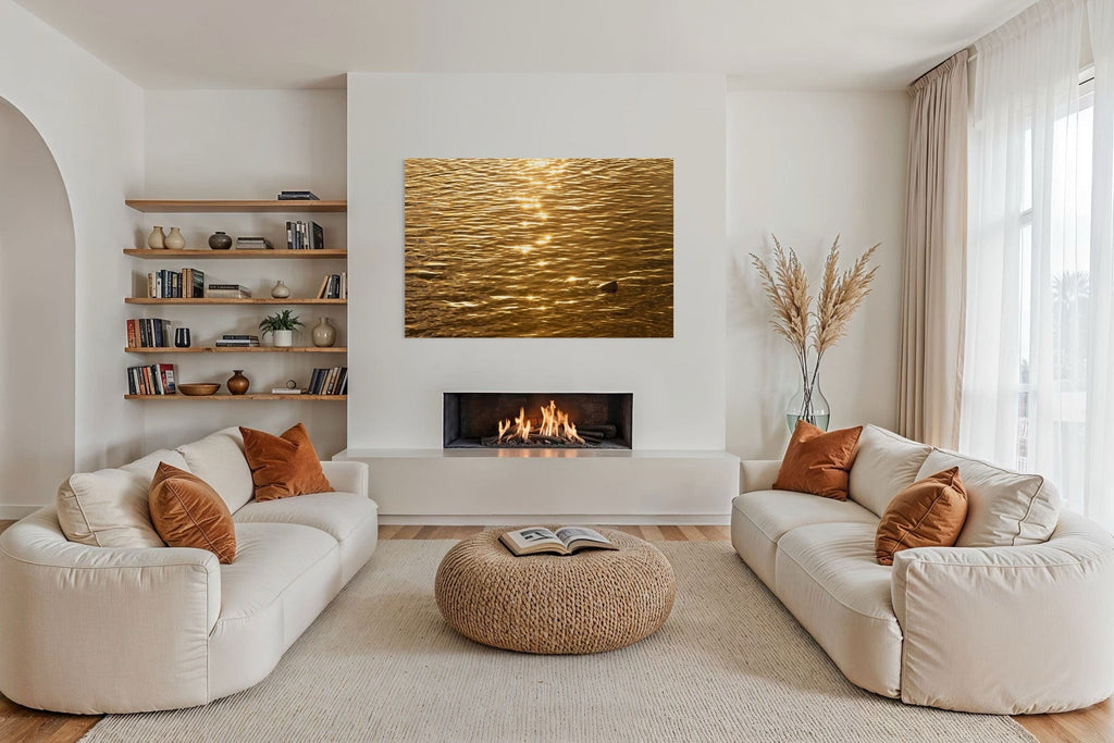 A piece of Kauai art showing a photo of a Kapaa sunrise reflected on the ocean hangs in a living room.