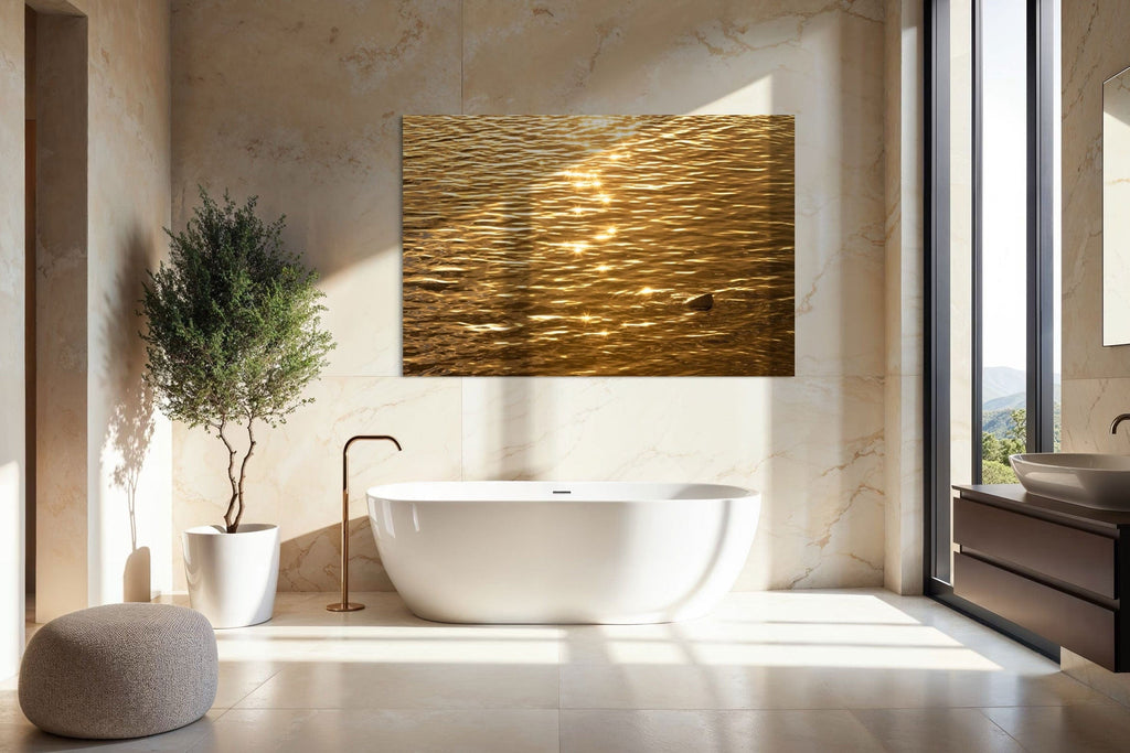 A piece of Kauai art showing a photo of a Kapaa sunrise reflected in the water hangs in a bathroom.