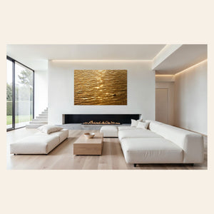 A piece of Kauai art showing a photo of a Kapaa sunrise reflected in the water hangs above a fireplace.