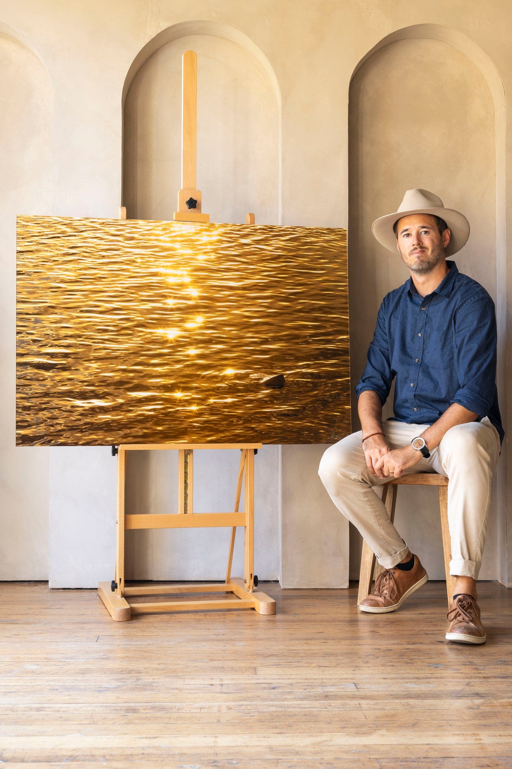 West Seattle artist Lars Gesing with his piece of Kauai art showing a Kapaa sunrise.