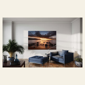 A Hanalei Bay sunset picture from Kauai hangs in a living room.