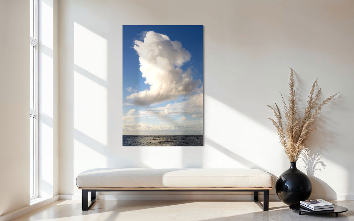 A piece of Kauai art showing a cloud photo over the ocean hangs in an entryway.