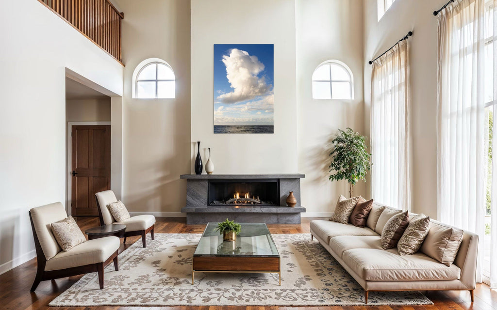 A piece of Kauai art showing a cloud photo over the ocean hangs above a fireplace.