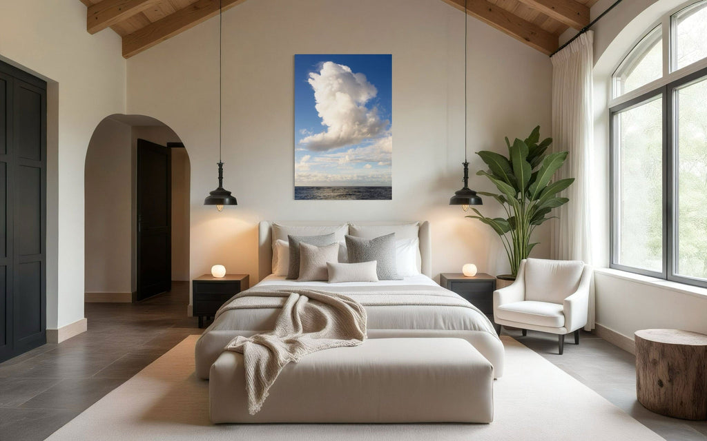 A piece of Kauai art showing a cloud photo over the ocean hangs in a bedroom.