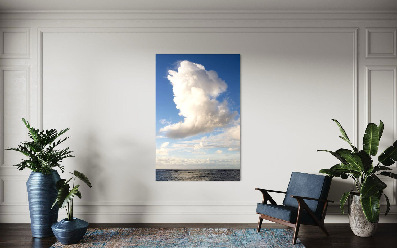 A piece of Kauai art showing a cloud photo over the ocean hangs in a sitting area.