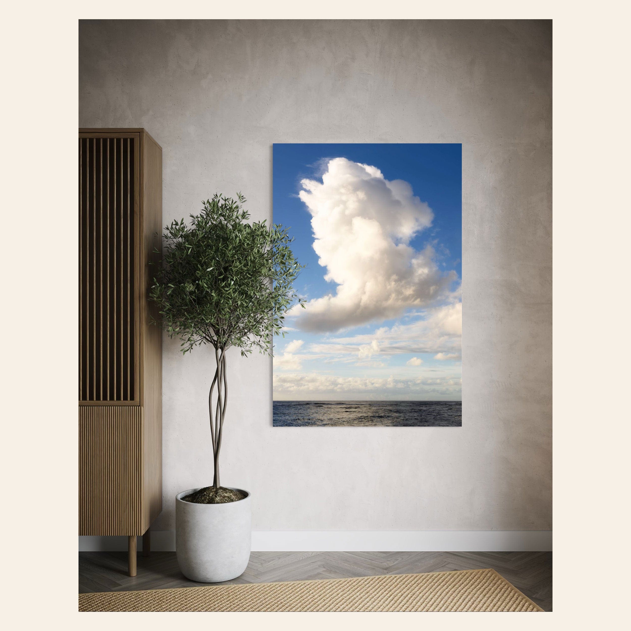 A piece of Kauai art showing a cloud photo over the ocean hangs next to a dresser.