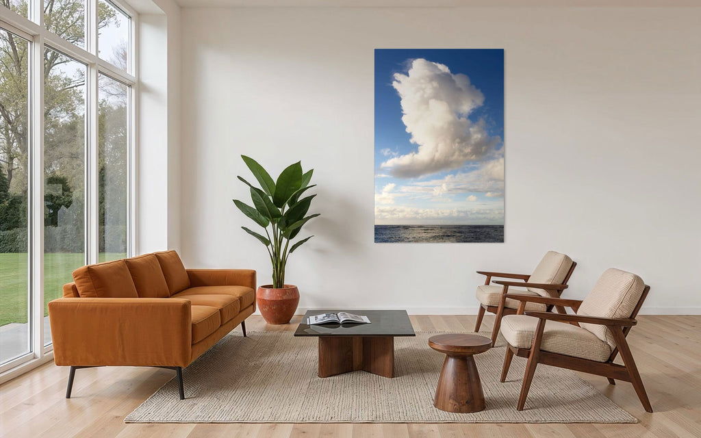 A piece of Kauai art showing a cloud photo over the ocean hangs in a family room.