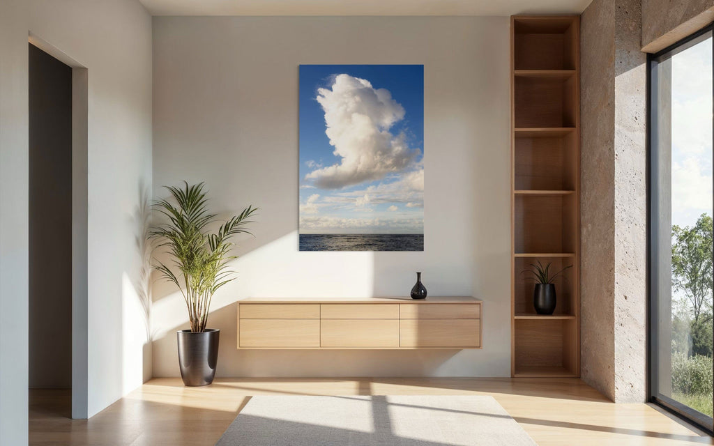 A piece of Kauai art showing a cloud photo over the ocean hangs in a living space.