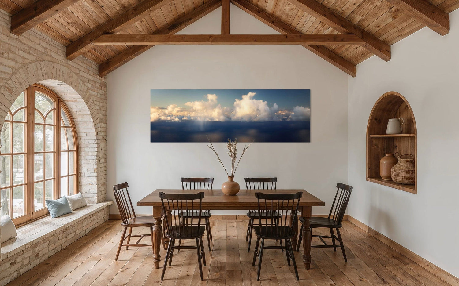 A piece of Kauai art showing a photo of clouds along the Napali Coast hangs in a dining room.