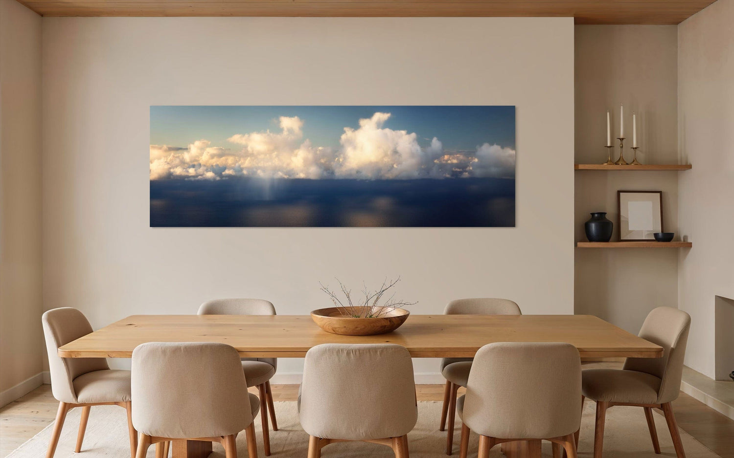 A piece of Kauai art showing a photo of clouds along the Napali Coast hangs in a dining area.