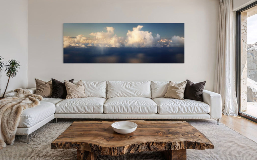 A piece of Kauai art showing a photo of clouds along the Napali Coast hangs over a couch.