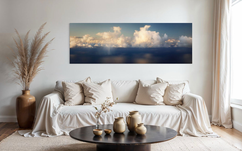 A piece of Kauai art showing a photo of clouds along the Napali Coast hangs in a living room.