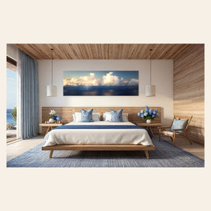 A piece of Kauai art showing a photo of clouds along the Napali Coast hangs in a bedroom.