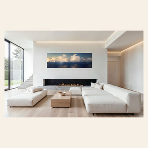 A piece of Kauai art showing a photo of clouds along the Napali Coast hangs above a fireplace.