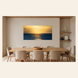 A piece of art showing one of the many good Kauai sunsets hangs in a dining area.