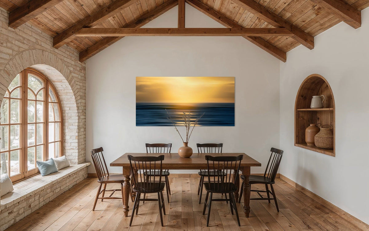 A piece of art showing one of the many good Kauai sunsets hangs in a dining room.