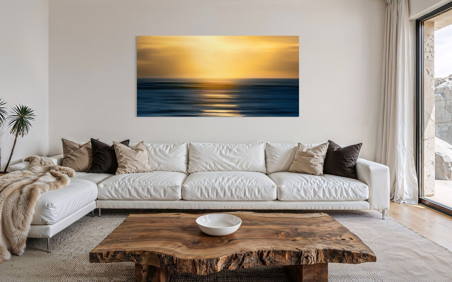 A piece of art showing one of the many good Kauai sunsets hangs above a couch.