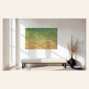 A piece of Kauai art showing the colors of the water on the ocean surface hangs in an entryway.