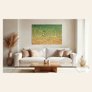 A piece of Kauai art showing the colors of the water on the ocean surface hangs above a couch.