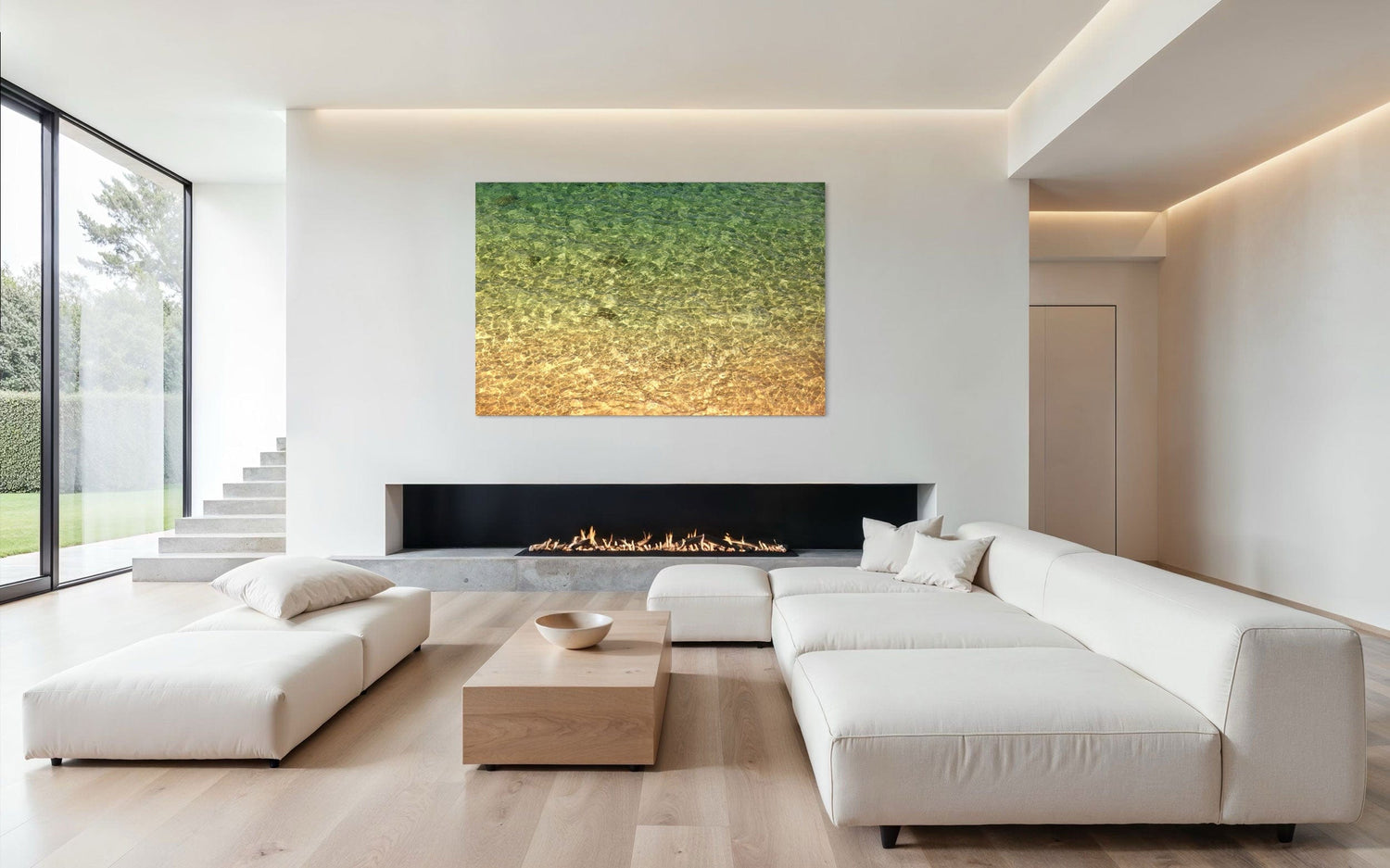 A piece of Kauai art showing the colors of the water on the ocean surface hangs above a fireplace.