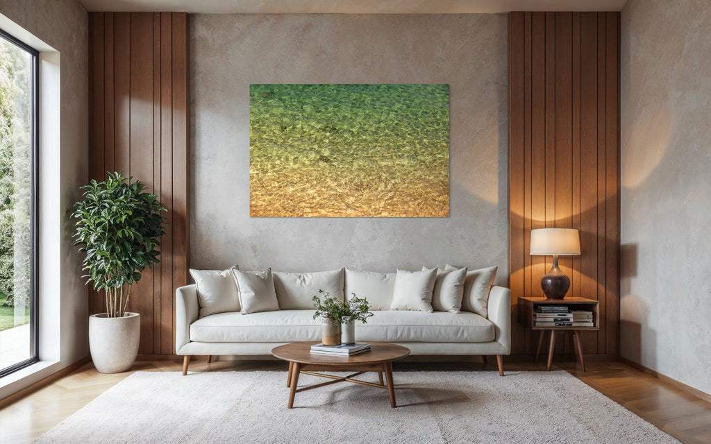 A piece of Kauai art showing the colors of the water on the ocean surface hangs in a living room over a couch.