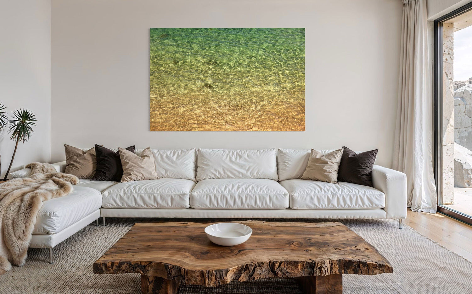 A piece of Kauai art showing the colors of the water on the ocean surface hangs in a living room.