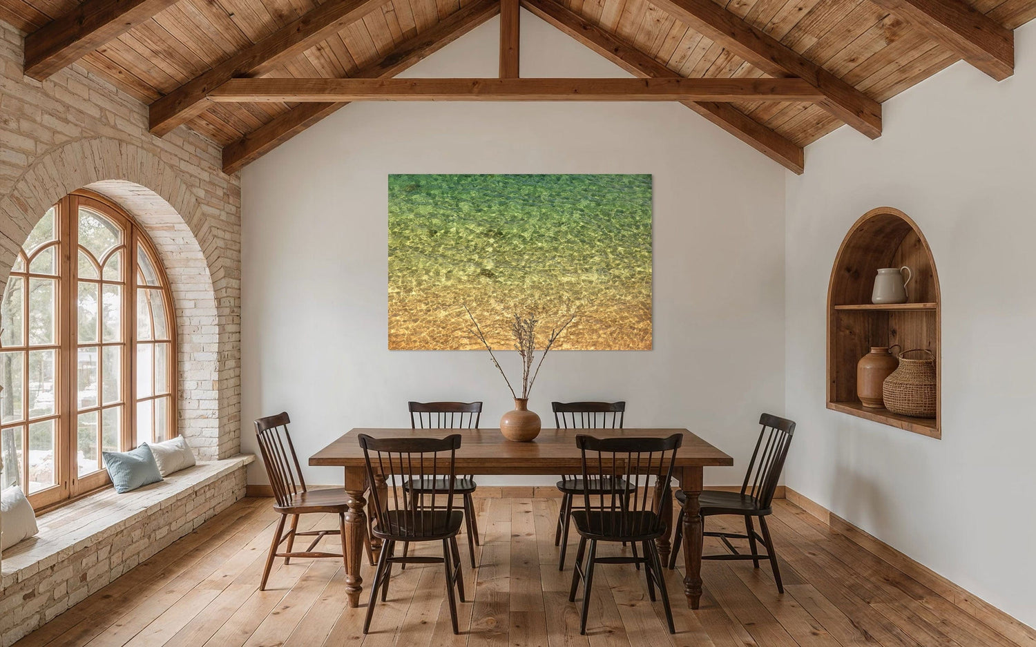 A piece of Kauai art showing the colors of the water on the ocean surface hangs in a dining room.