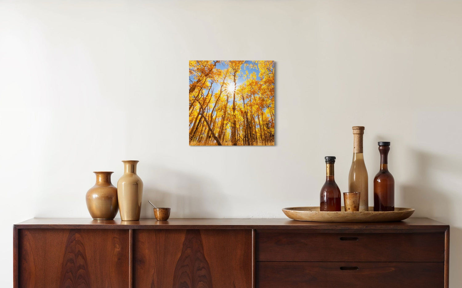 A piece of Colorado art showing a Kenosha Pass peak fall color photo hangs in a dining room.