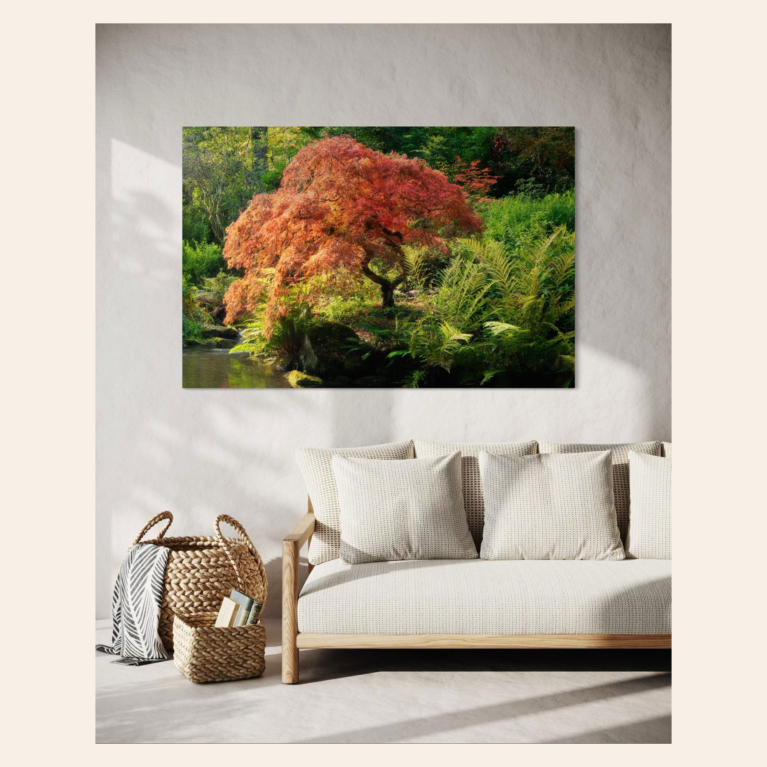 A piece of Seattle wall art showing a Japanese maple tree picture at Kubota Garden hangs in a living room.