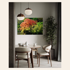 A piece of Seattle wall art showing a Japanese maple tree picture at Kubota Garden hangs in a dining room.