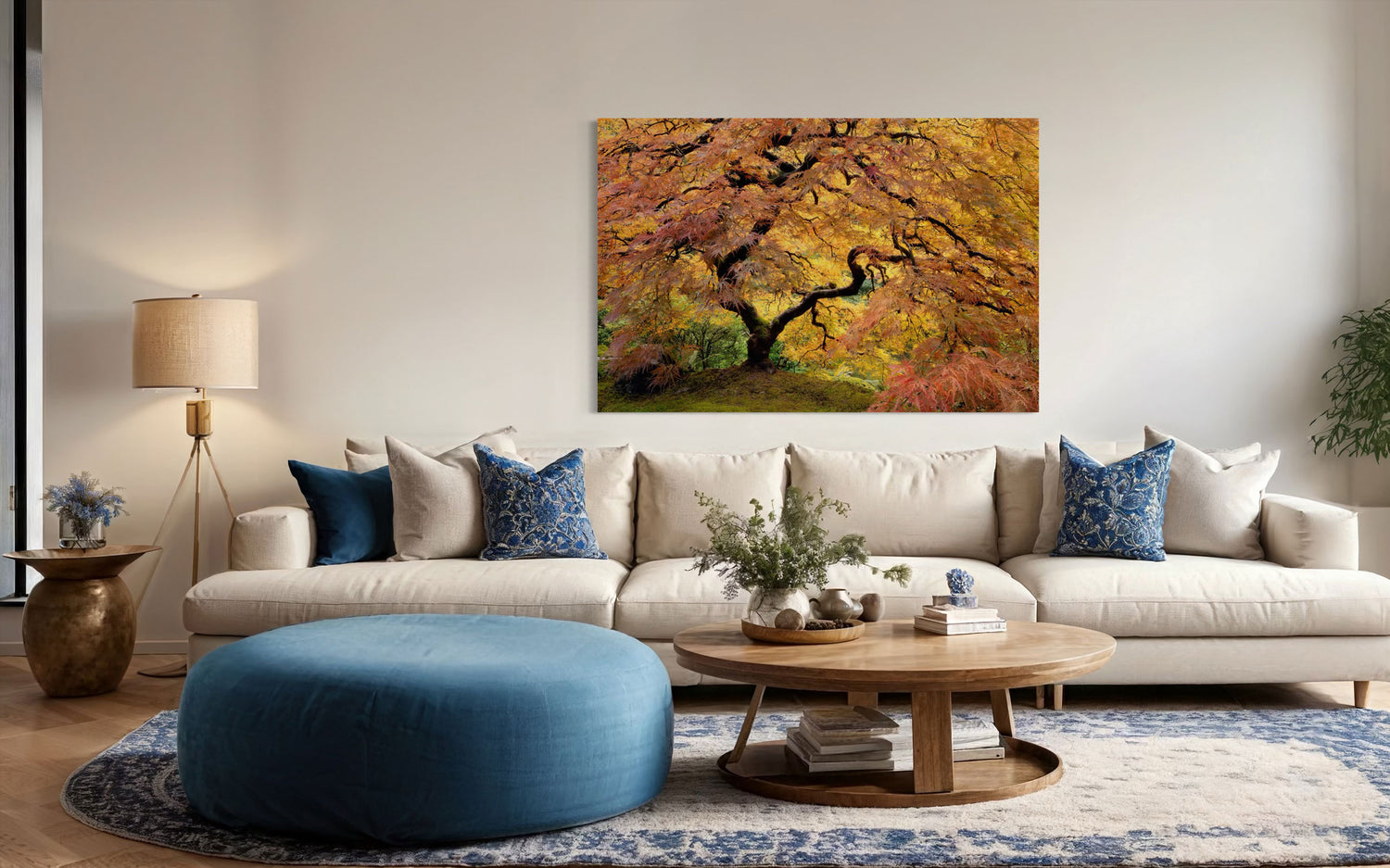 A piece of large wall art showing a Japanese maple from the Portland Japanese Garden hangs in a living room.