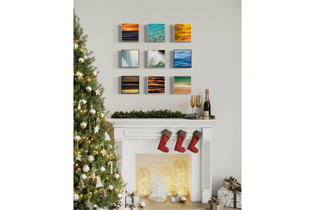 A variety of Lars Gesing water art boxes hang above a fireplace.